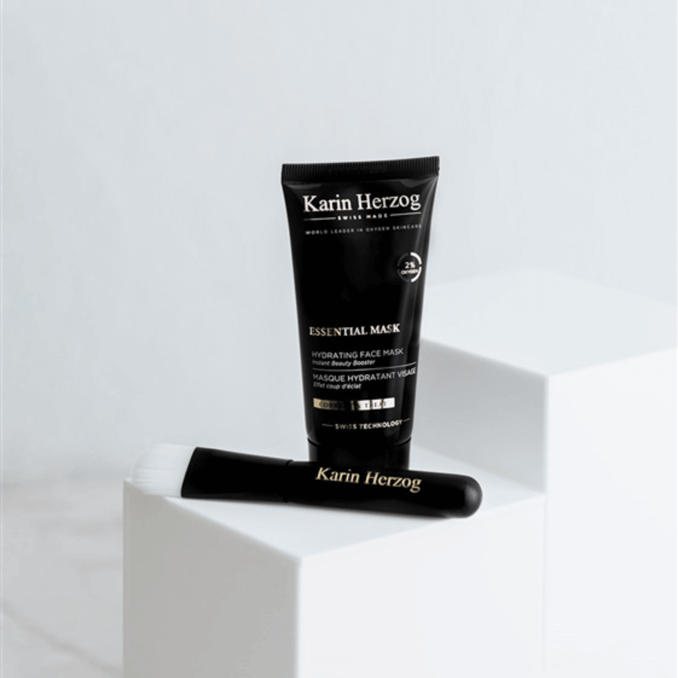 Karin Herzog Essential Mask 50ml and Face Brush displayed on a white surface: a hydrating face mask with 2% active oxygen for glowing skin.