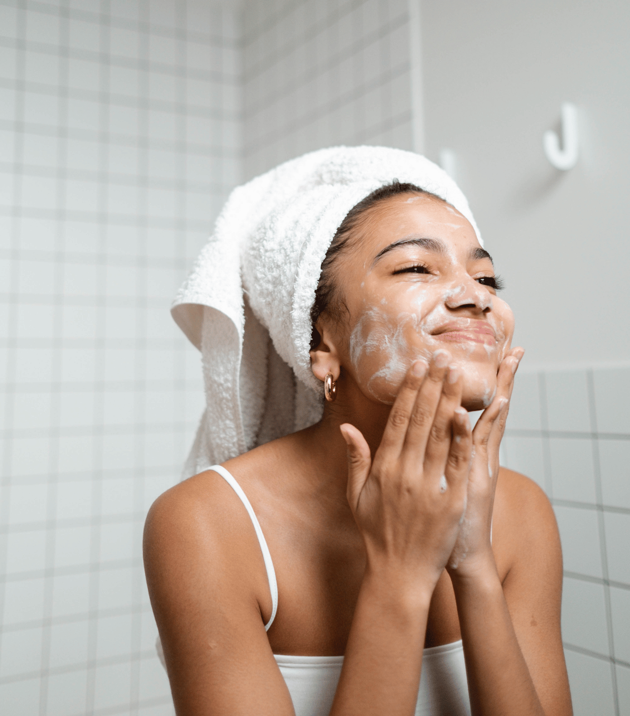 A woman having a skincare routine using the evening kit from Karin Herzog