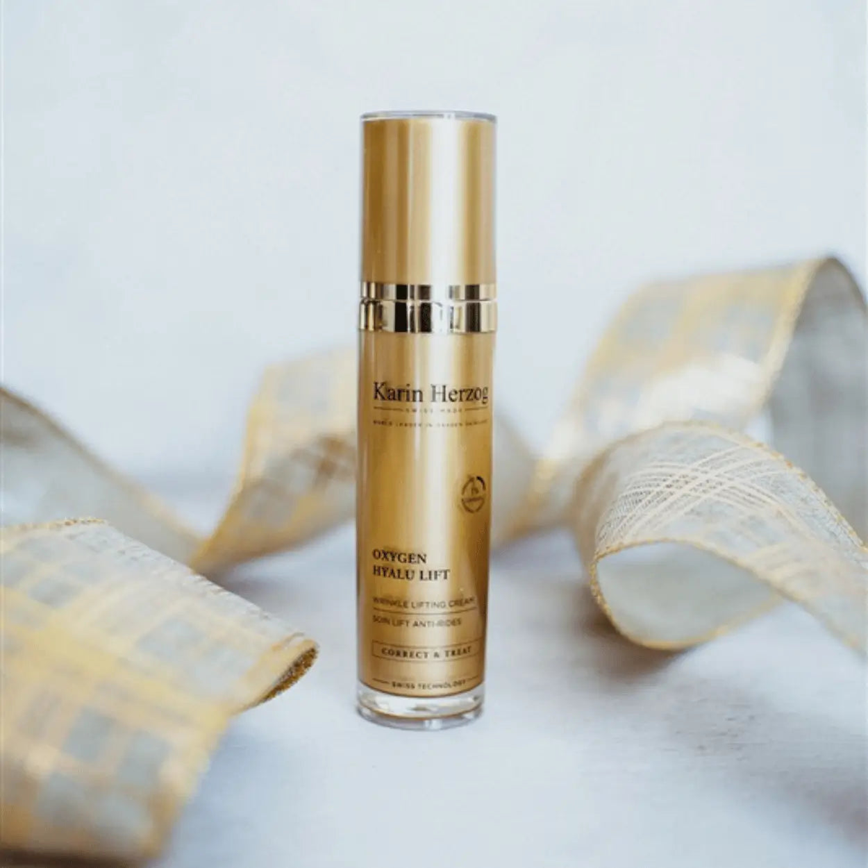 Karin Herzog Oxygen Hyalu Lift 30ml lifting cream standing upright on a white surface, surrounded by gold-accented decorative ribbon for a festive, luxurious feel.